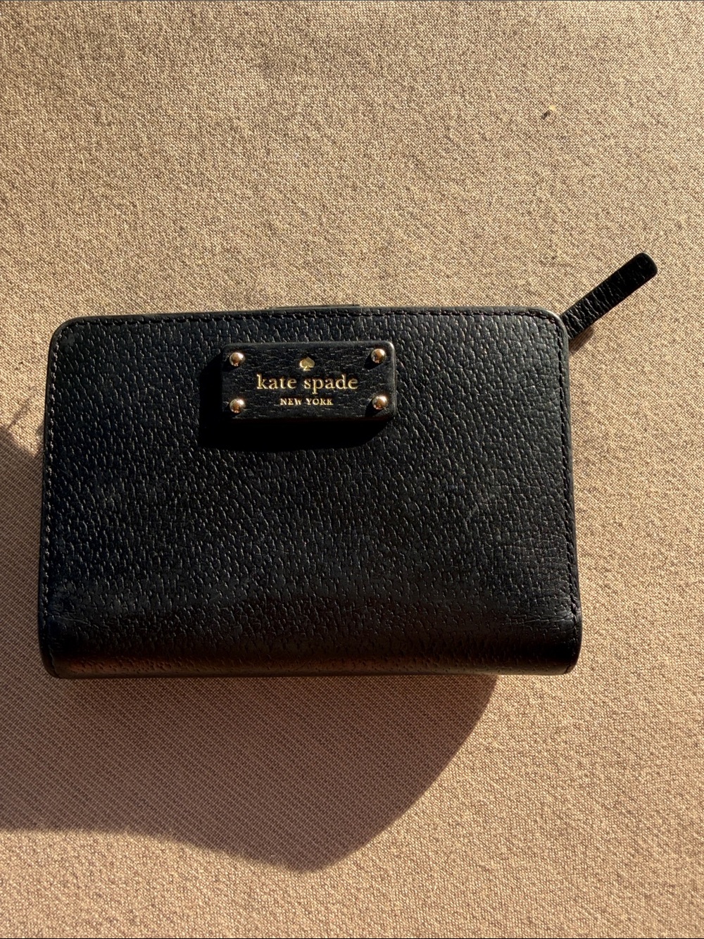 kate spade black pebble leather zip-around wallet with gold logo